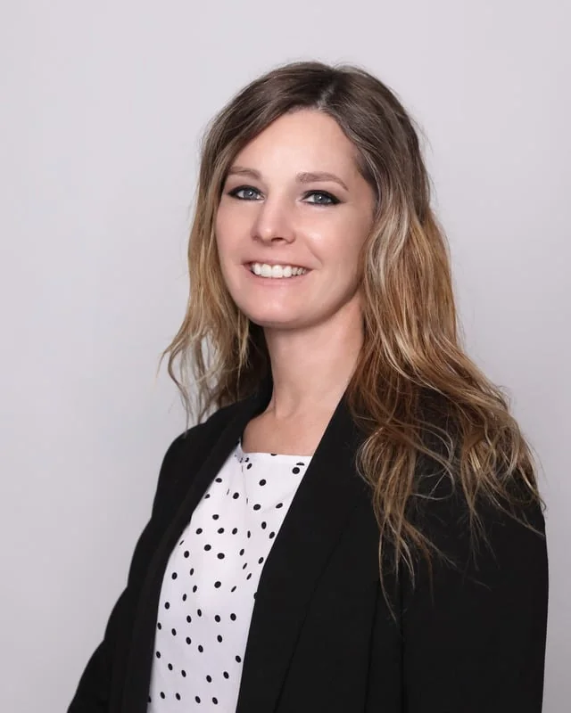 Corporate headshot, man in a dark suit
